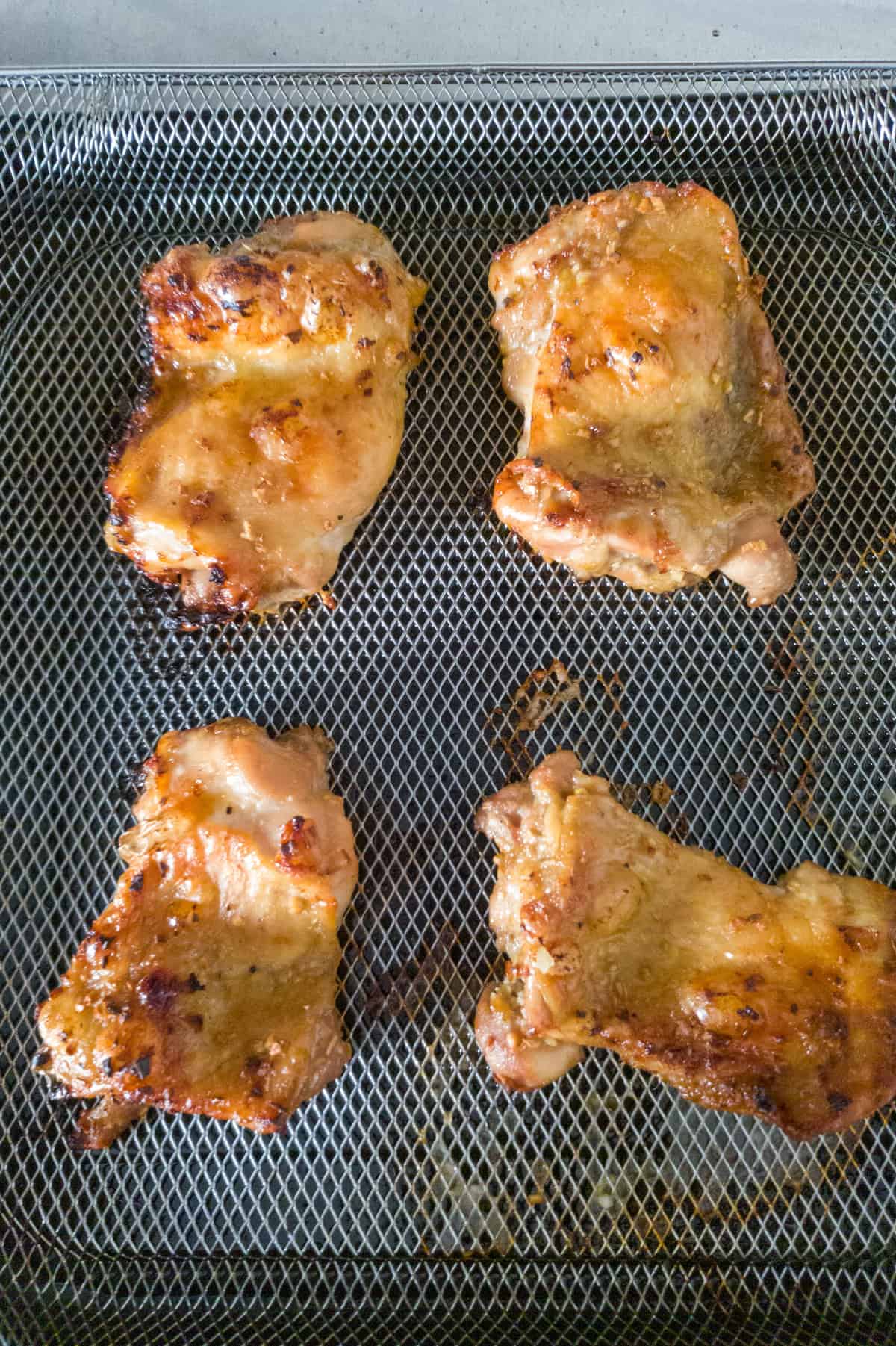 Cooked chicken on air fryer tray