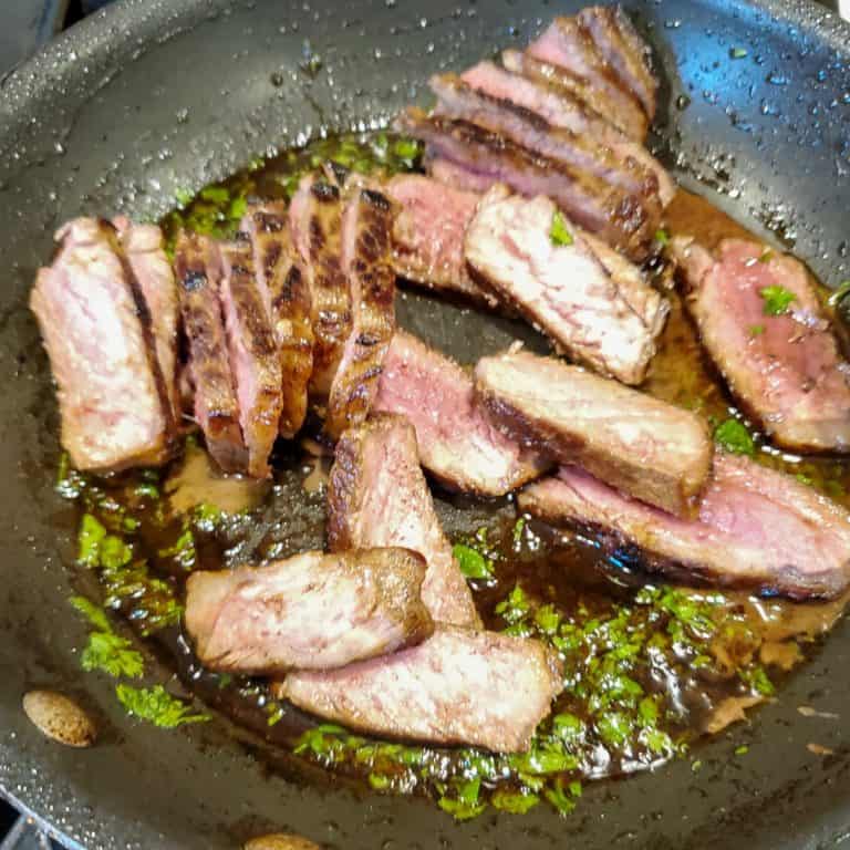 Sliced steak in pan