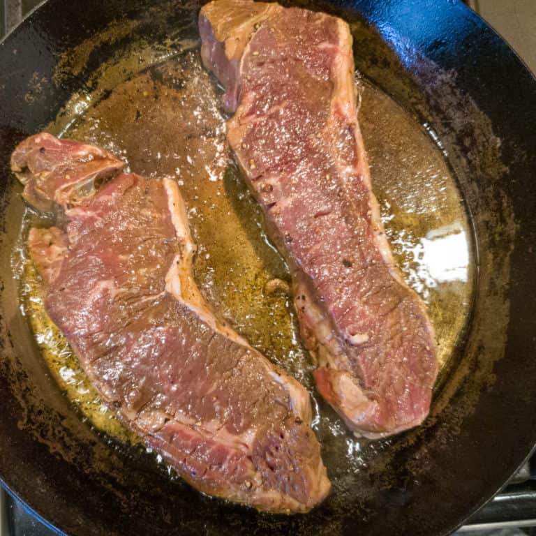 Cooking steak in pan