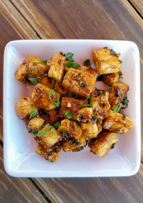 Fried tofu with teriyaki sauce topped with green onions